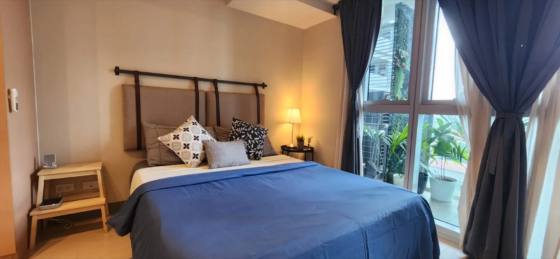 Uptown Parksuites Tower 2 Unit 7U — furnished bedroom with floor-to-ceiling windows and BGC skyline view